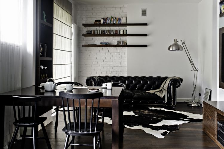 Black dining chair in a monochrome-themed apartment