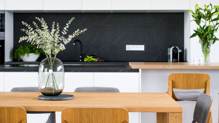 A contemporary kitchen space featuring natural furniture and minimalist design