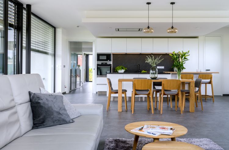 A kitchen with a beautiful blend of modernity, natural furniture, and clean design