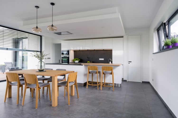 A modern kitchen with clean lines and natural furniture elements