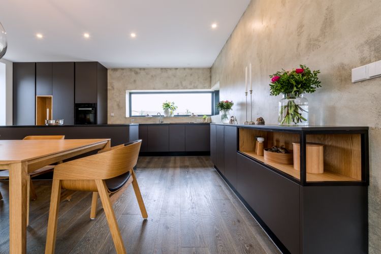 Interior of a chic house showcasing a modern kitchen and the Merano chair and armchair