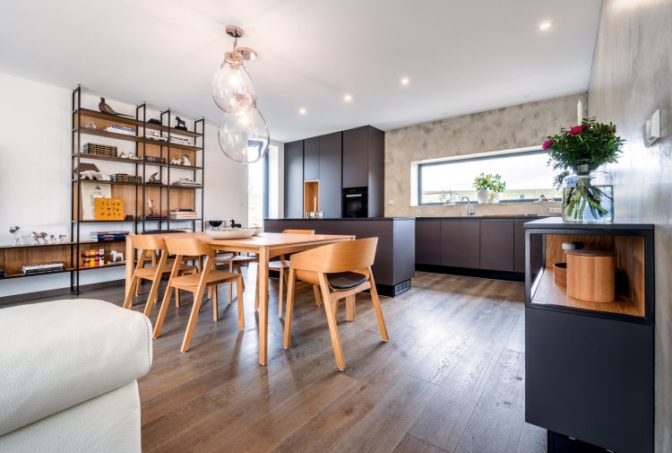 Contemporary home interior with a modern kitchen and elegant Merano chair and armchair