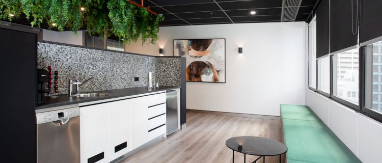 An airy modern office kitchen flooded with natural light