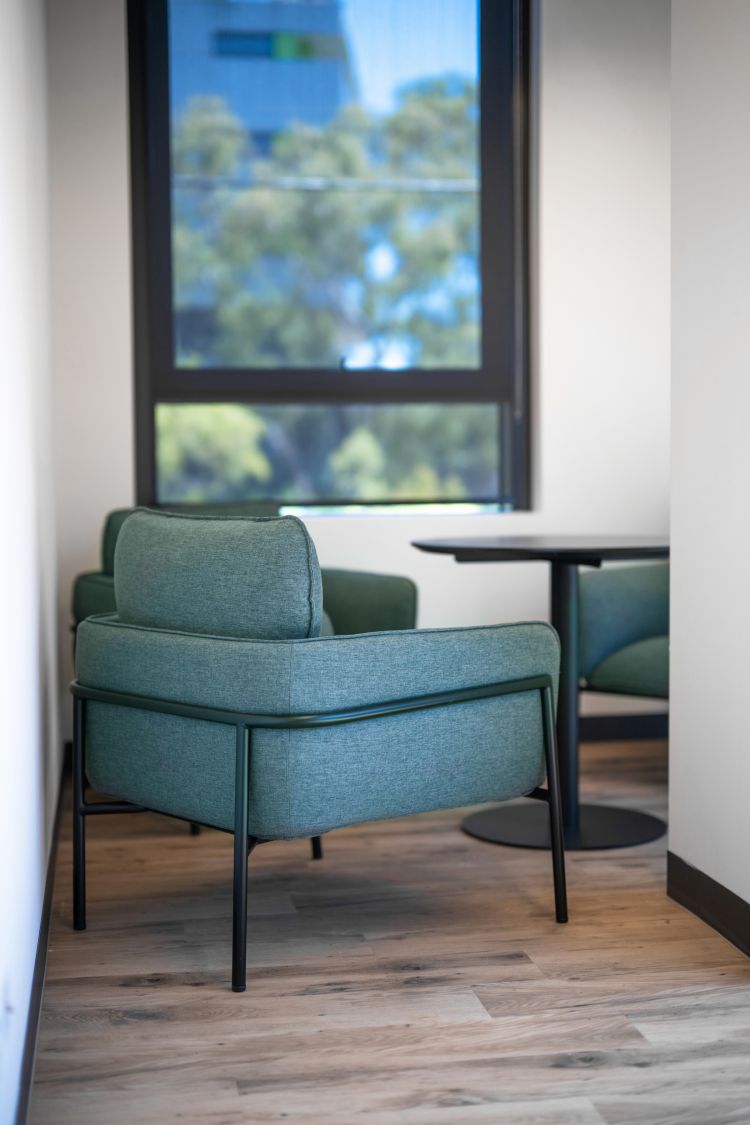 Green lounge chairs in the waiting area of an office