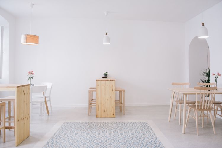 A serene and minimalist interior with a predominantly white palette.