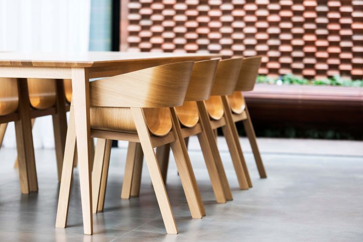 Merano wooden armchairs are lined up along the table