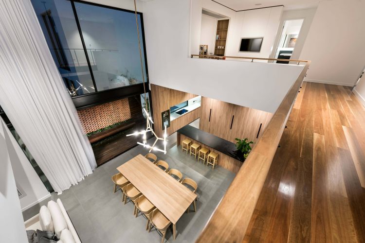 A spacious dining area boasts a wooden table surrounded by matching chairs.