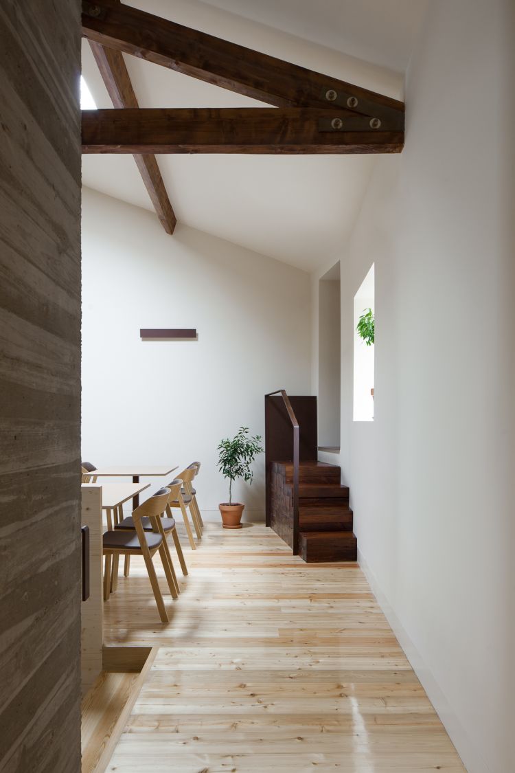 A hallway with wooden floor and white wall