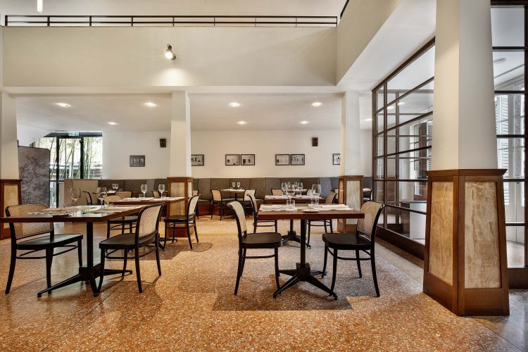 Spacious dining area in a restaurant with an architectural blend of modern and classic design.