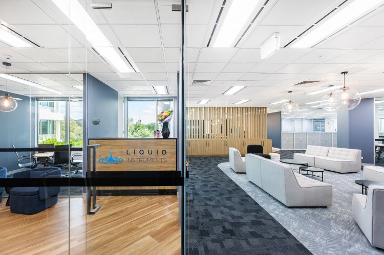 Spacious modern office interior of Liquid Instruments featuring a bright ambiance with large glass partitions.