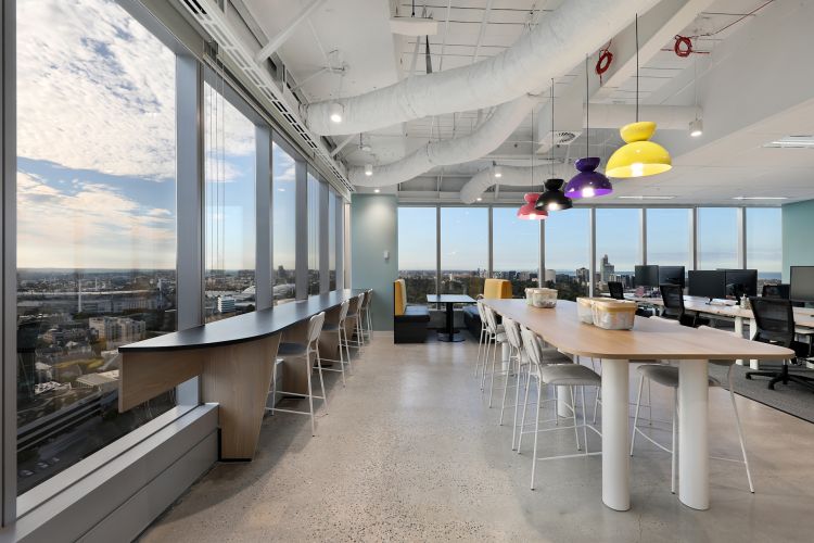 Contemporary office space with floor-to-ceiling windows offering a panoramic view of the city. 
