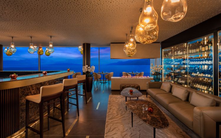 The room features a marble bar counter with modern wooden stools