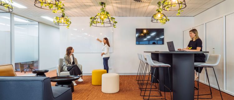 Modern office space featuring vibrant hanging plant lights, and contemporary seating arrangements