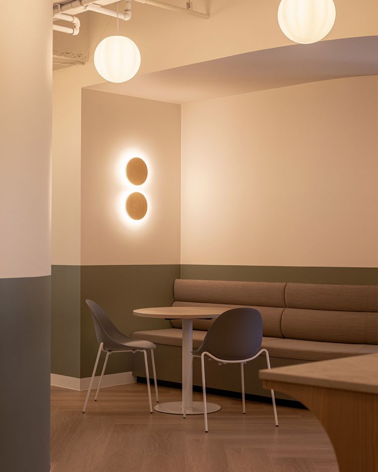 A calm and softly lit office breakout area with modern decor.