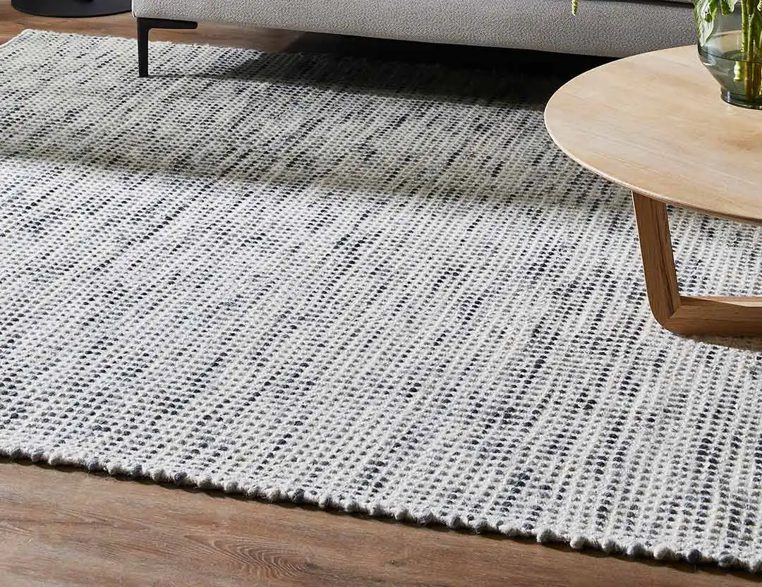 Kobe Wool Rug in Mist blue flecked with charcoal, set with grey sofa and timber coffee table