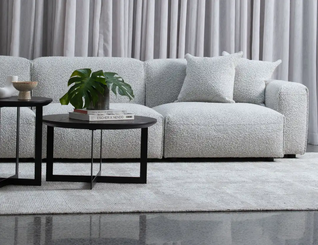 Garcia Wool Rug in Oyster grey with black stacked coffee tables and grey sofa