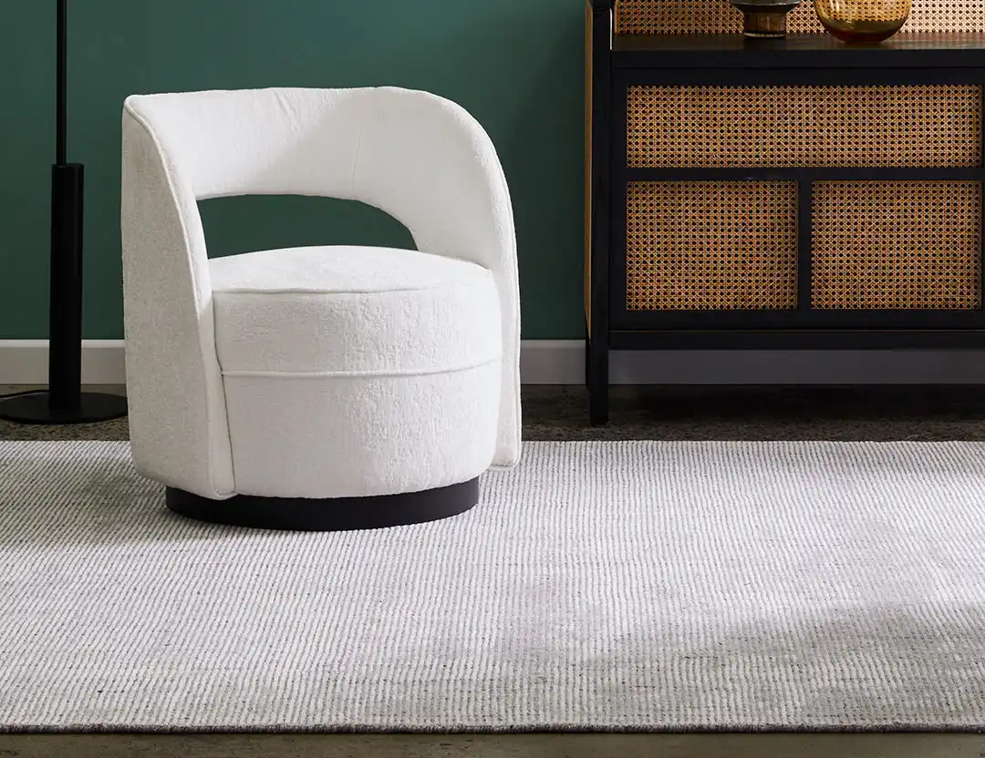 Garcia Wool Rug in Whisper light grey with beige chair and green walls