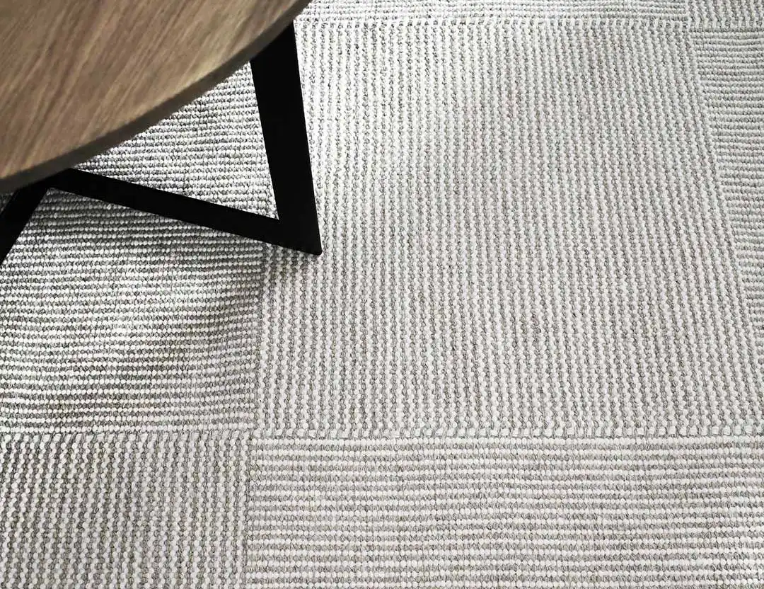 Braid Box wool rug in natural with an oak coffee table and black frame
