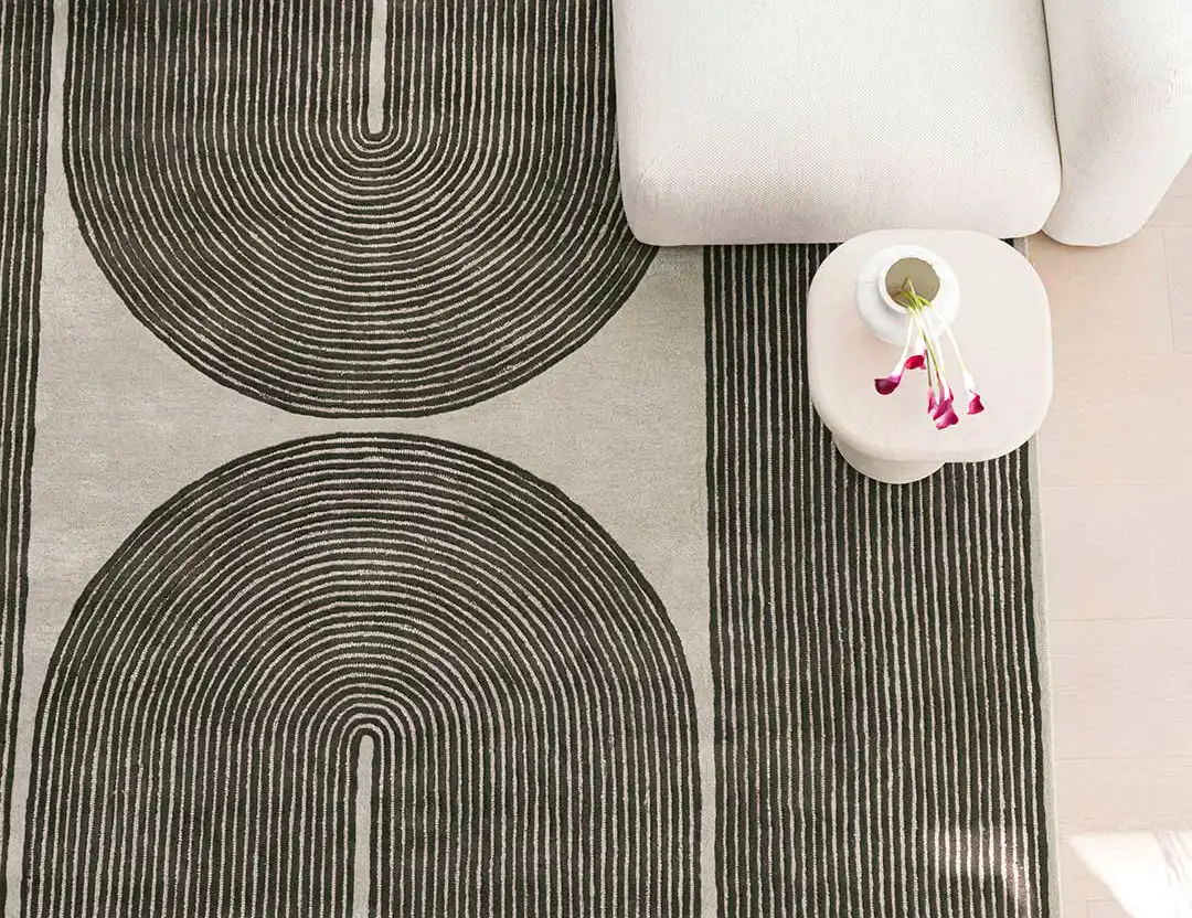 Viper Wool Patterned Rug in olive green with beige sofa and orchids