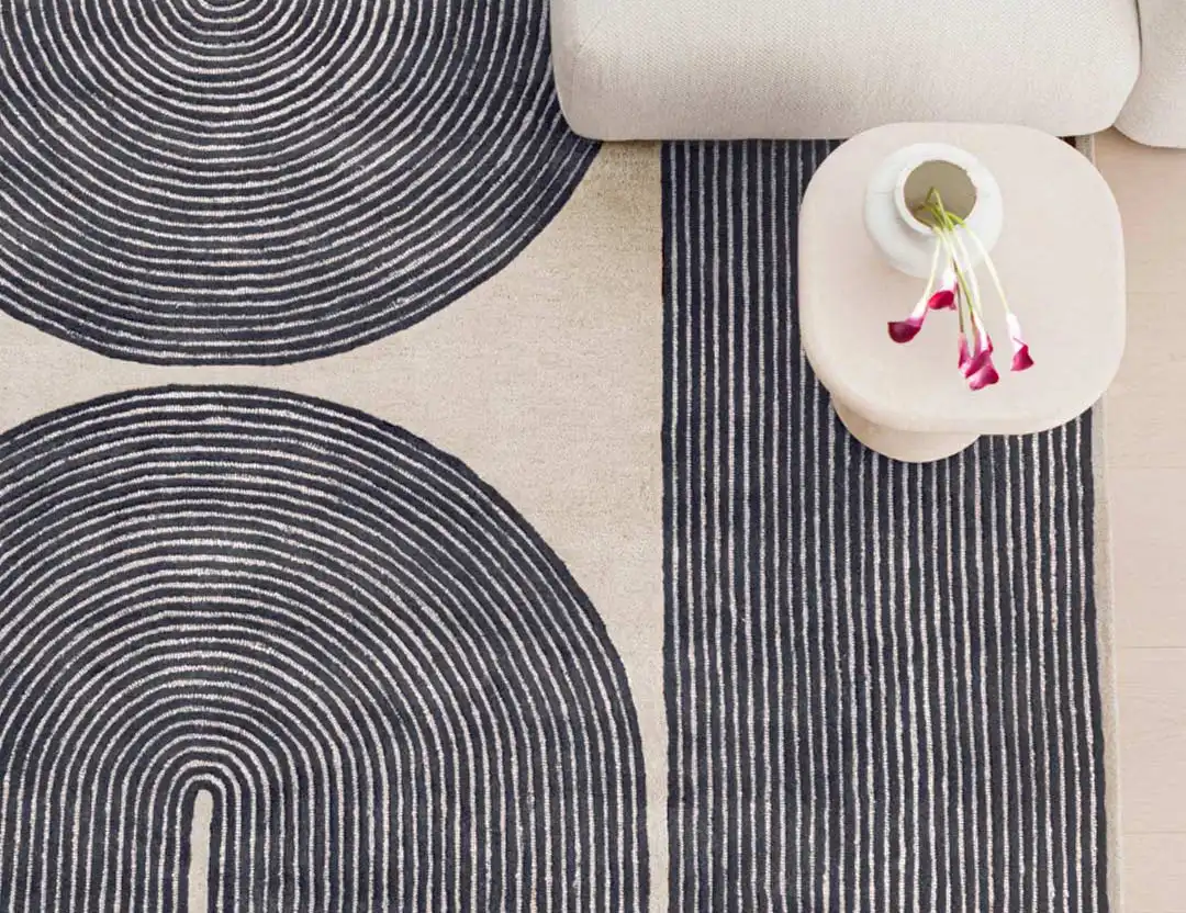 Viper Wool Patterned Rug in Ink blue with beige sofa and orchids