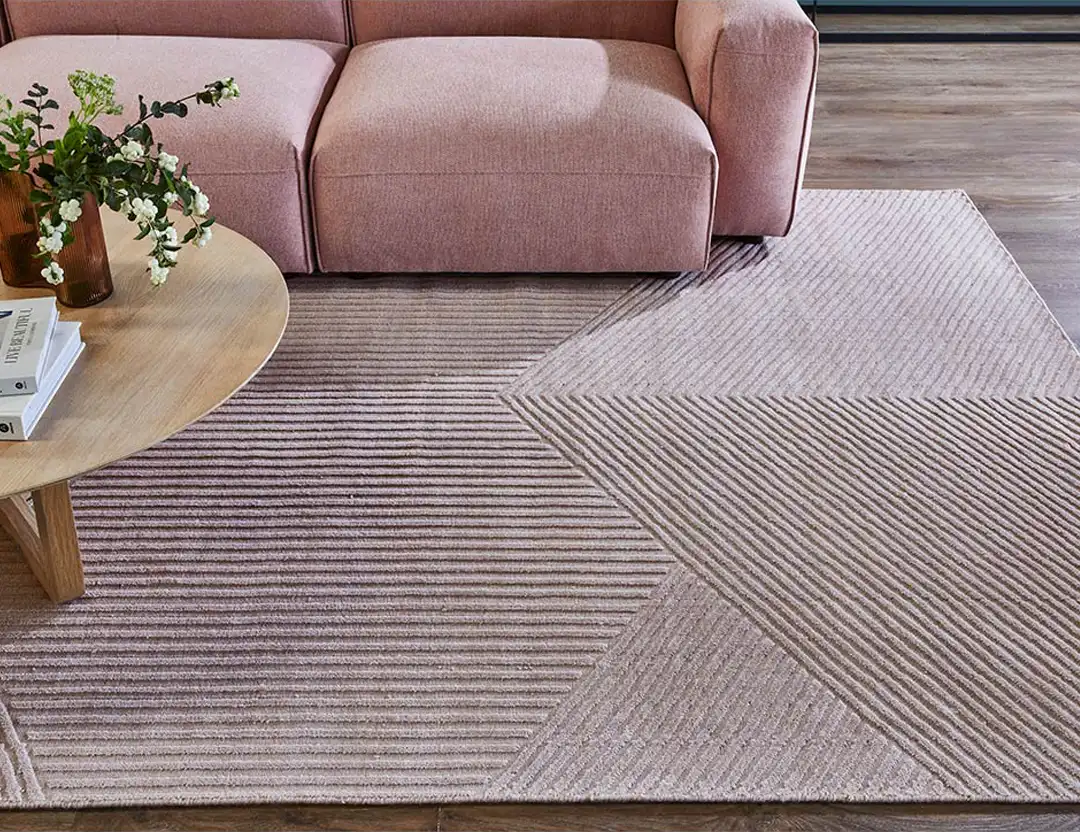Abstract Elm Wool Rug in Dove grey with pink sofa and coffee table with flowers