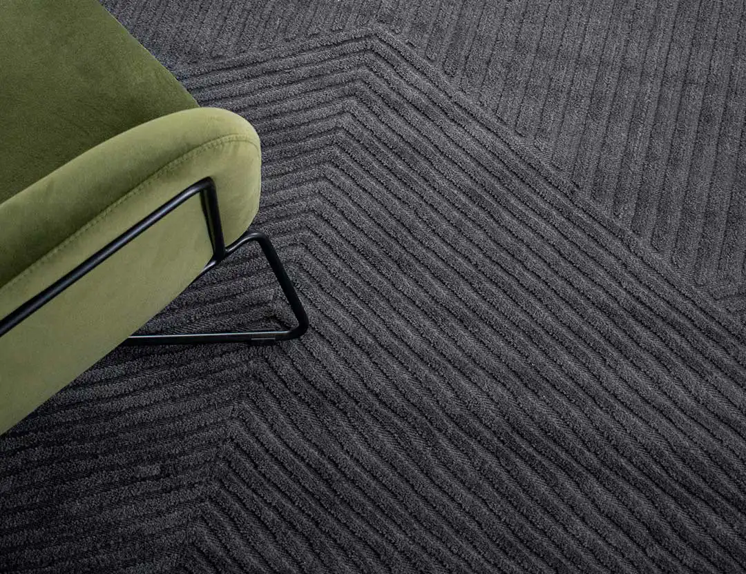 Abstract Elm Wool Rug in Ink blue with green armchair