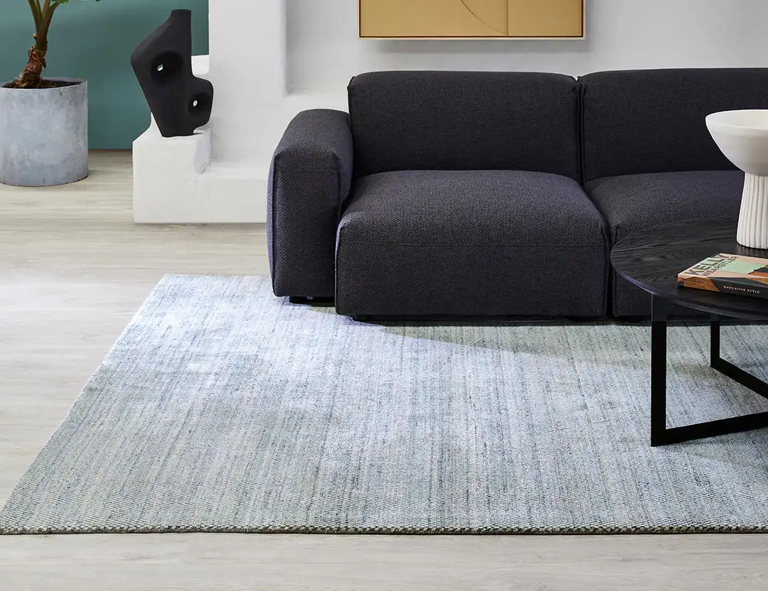 Mystique Wool Rug in Denim Ivory marle with a charcoal sofa and black coffee table