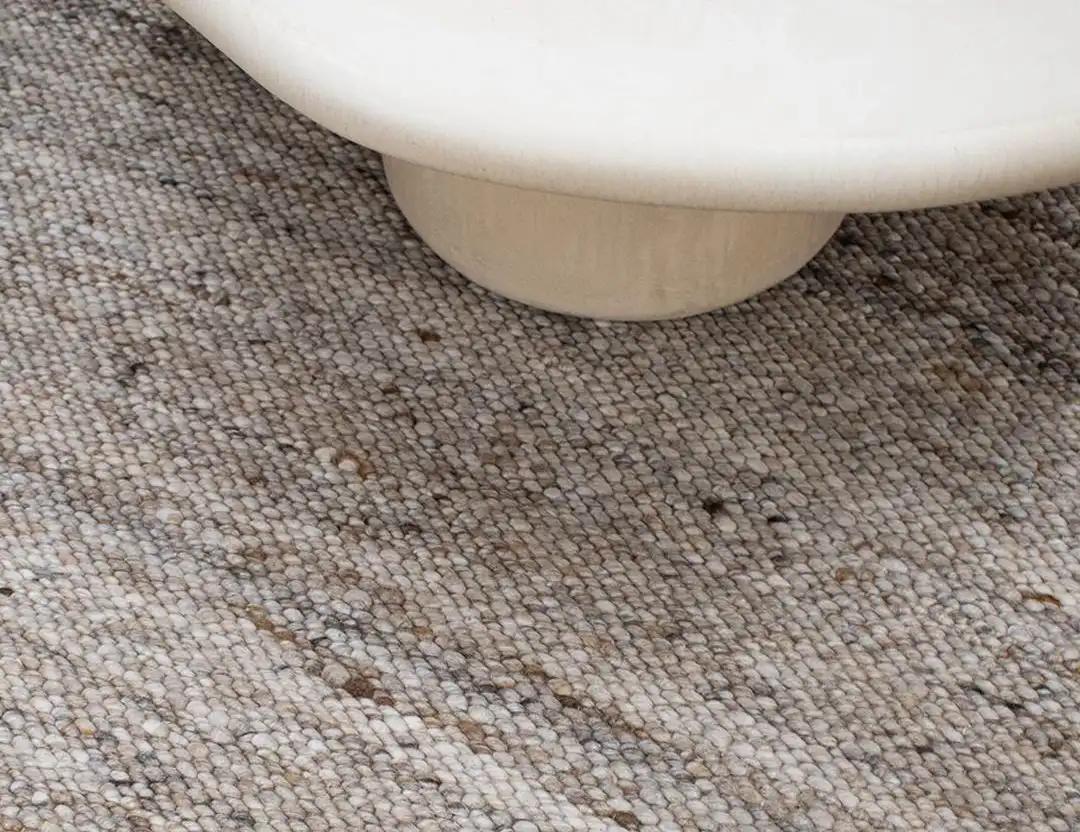Frida Wool Rug in Caramel brown marle with a beige coffee table