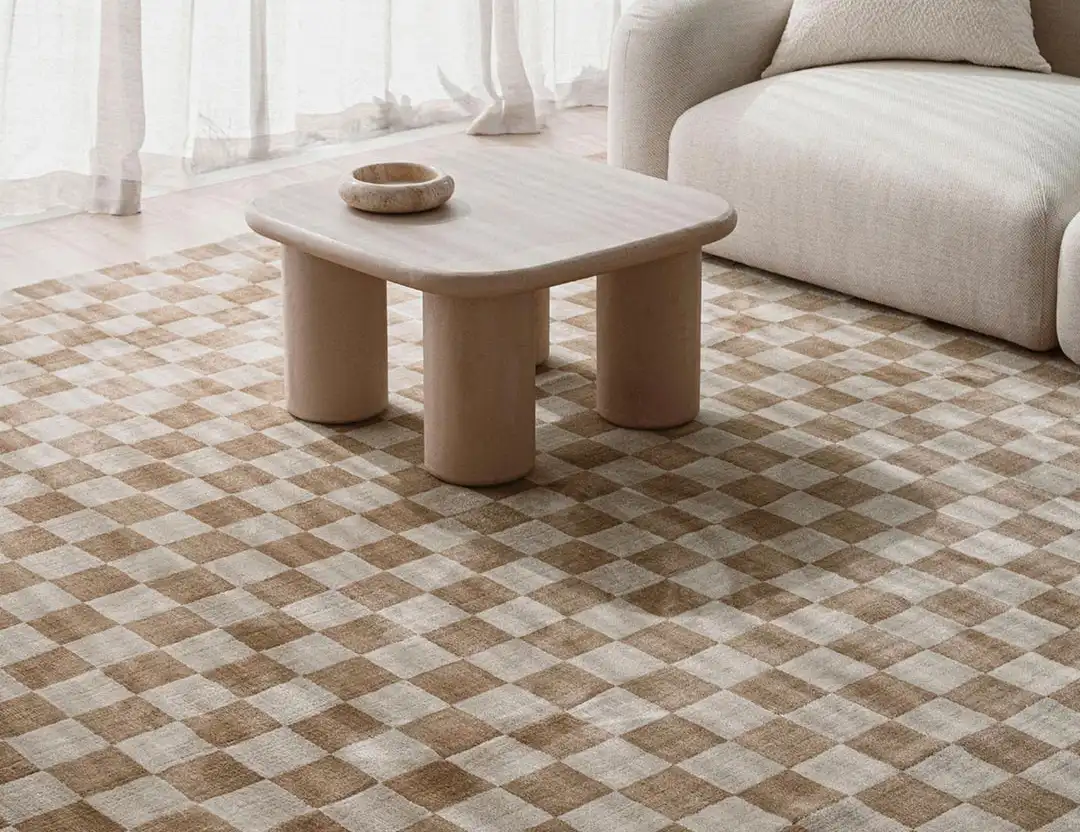 Calcada UV resistant Rug. light brown & beige check rug with beige sofa by the window