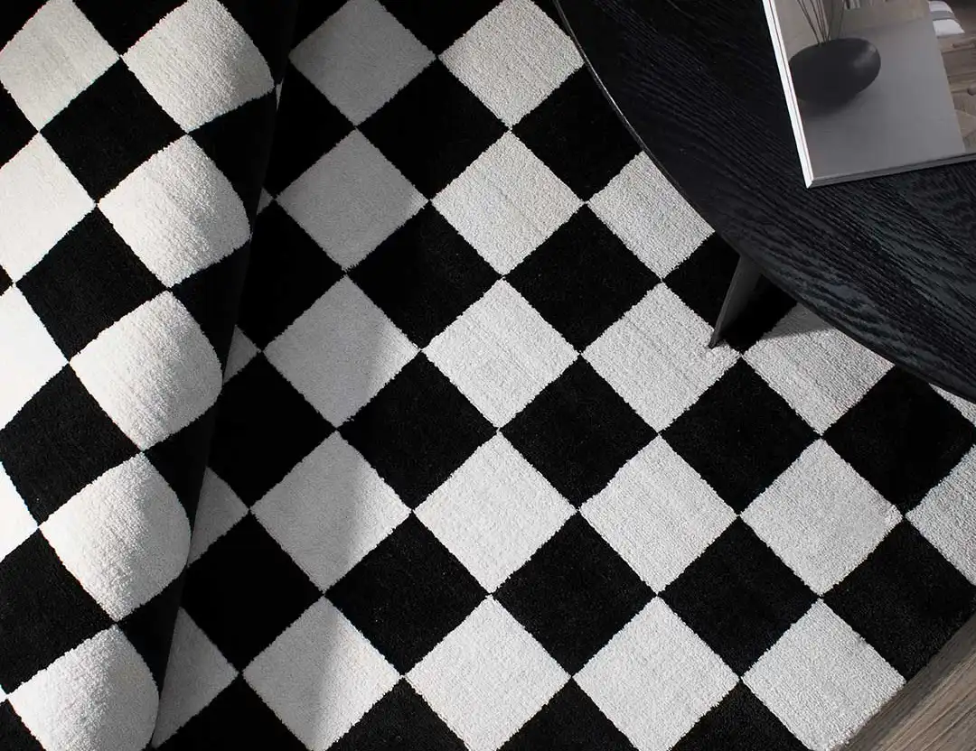 Calcada UV resistant Rug. Black & White check rug with black coffee table and open magazine