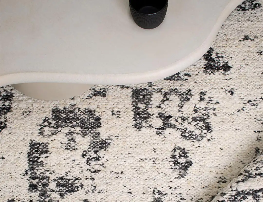 Kasbah Boho Wool Rug in White/Black with curvy beige coffee table