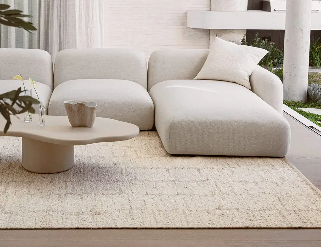 Kasbah Boho Wool Rug in Ivory & Beige with beige sofa and open outdoor screen