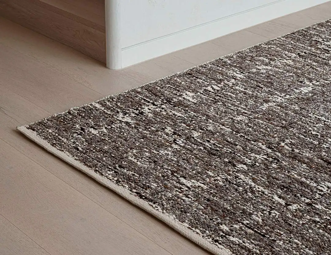 Kasbah Boho Wool Rug in Brown on oak floorboards